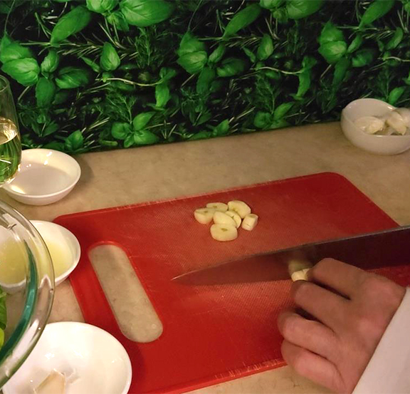 This is a photo of me chopping garlic for my Spinach Pesto.