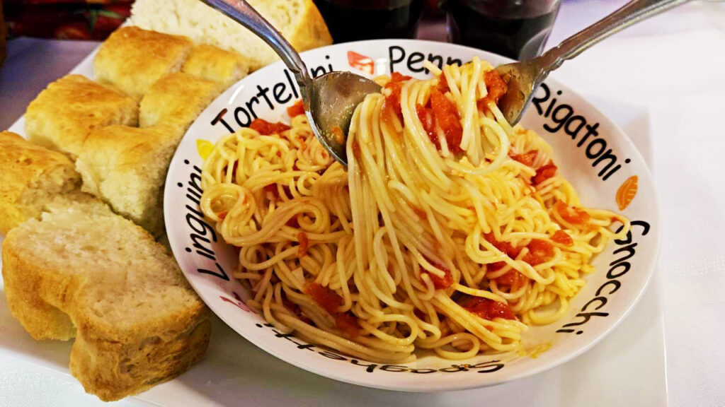 photo of pasta twirling on fork and spoon